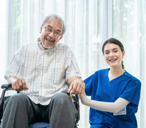 image of an elderly man with a female caregiver smiling