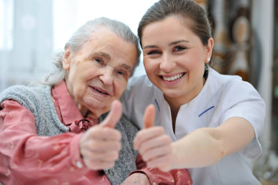 elderly and caregiver smiling